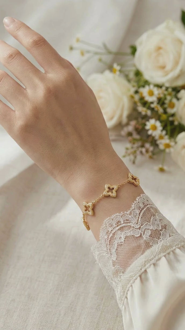 Close-up of the silver open-cutout quatrefoil bracelet, perfect as a dainty bridal or bridesmaid accessory.