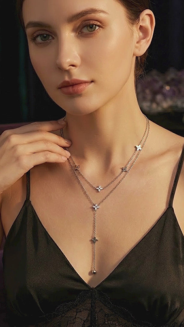 Stunning video display of the Layered Y-Necklace on a model in a black evening dress, showcasing the 10cm floral drop movement.