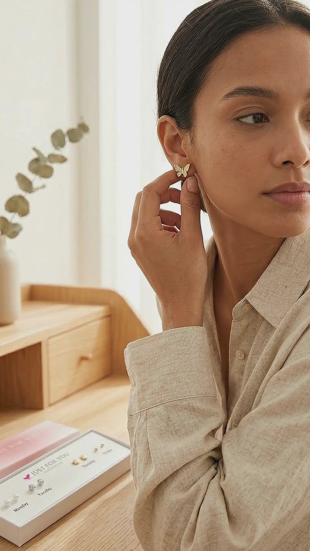 Lifestyle video presentation of the 5 pair days of the week earring set displayed on a table in a cozy home setting, highlighting soft casual styling and the mindful daily wearing experience of the silver studs.