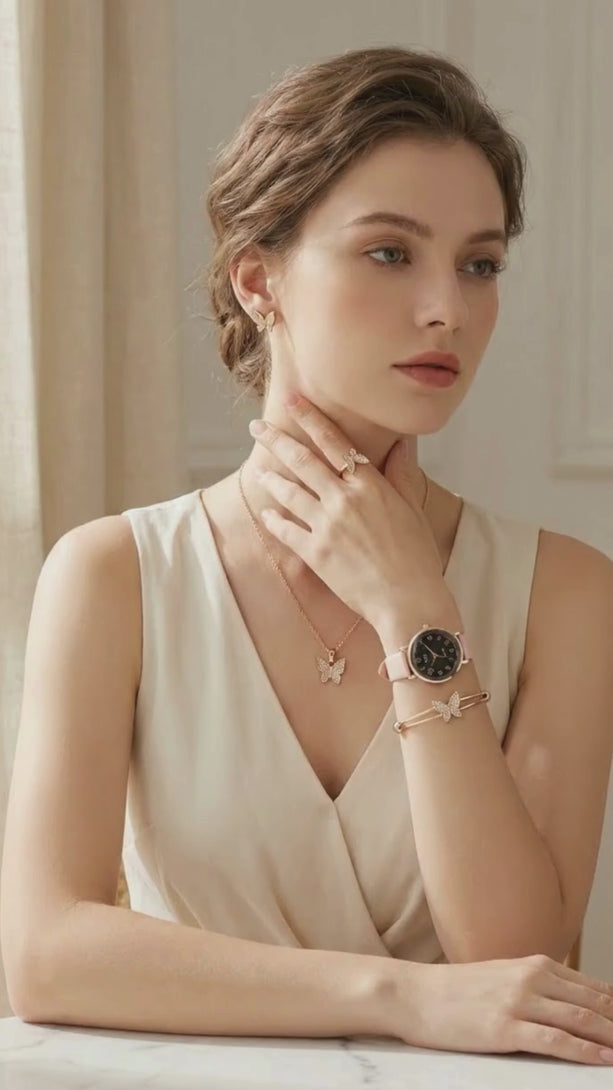 Lifestyle video showcasing a model in an elegant cream sleeveless dress wearing the sparkling 5-piece rose gold butterfly jewelry and watch set.