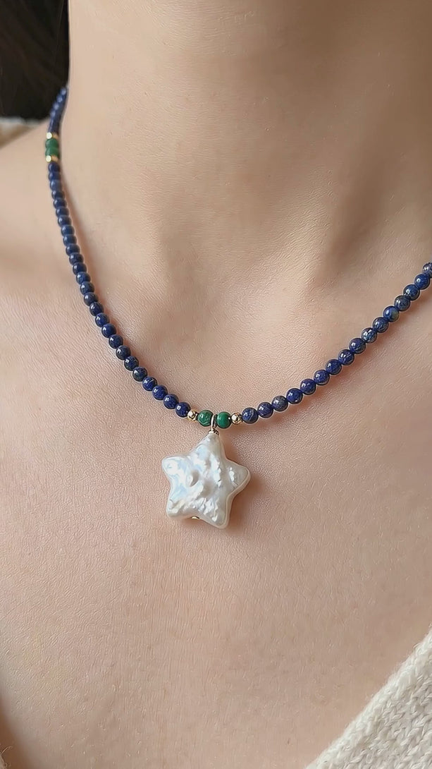 High definition macro video showcasing the intricate details of the Astre Crystals lapis lazuli choker, focusing on the 2.5mm deep oceanic blue beads and the iridescent glow of the star shaped baroque pearl pendant.